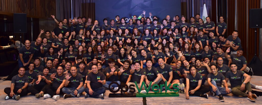 People in matching shirts together for a photograph.